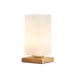 Solid wood table lamp with Nordic minimalist design, shown on a desk with warm ambient lighting