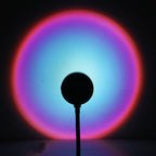 Sunset Projection Lamp casting a warm rainbow gradient light across a dark room, showcasing its ambient mood lighting effect