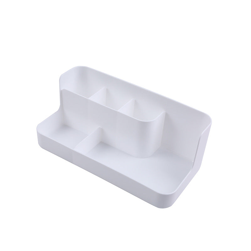 White desktop makeup organizer with 5 compartments holding brushes, lipsticks, and skincare products on a clean surface