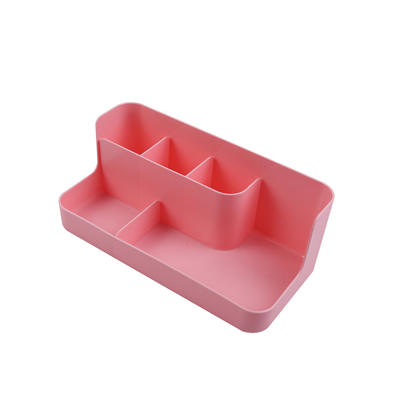 Clear desktop makeup organizer with 5 compartments holding brushes, lipsticks, and skincare products on a vanity