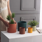 Colorful cylinder ceramic succulent planter with drainage hole, shown in a Nordic-inspired minimalist style