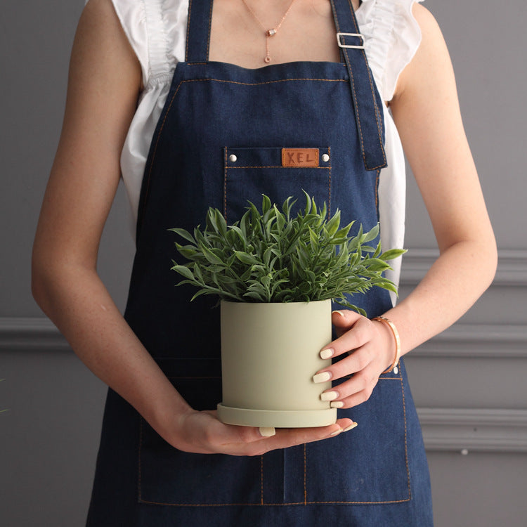 Colorful cylinder ceramic succulent planter with drainage hole, shown in a Nordic-inspired minimalist style