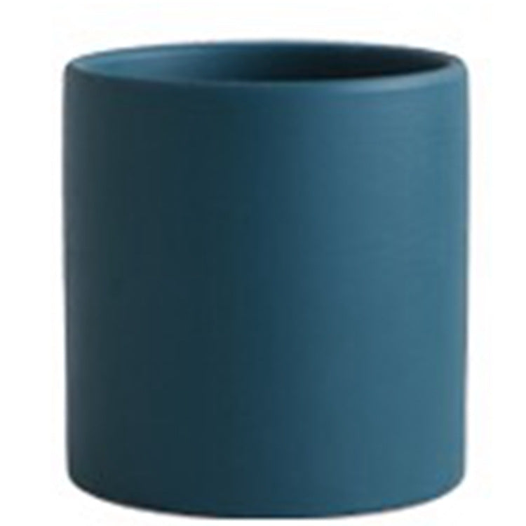 Colorful ceramic cylinder succulent planter with drainage hole, shown in a Nordic-inspired minimalist style