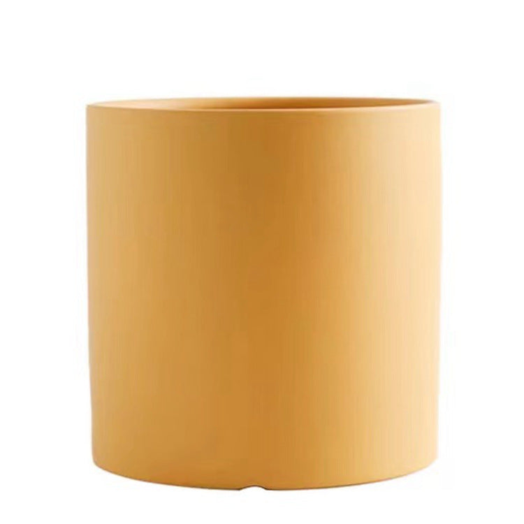 Colorful cylinder ceramic succulent planter with drainage hole, shown in a Nordic-inspired minimalist style