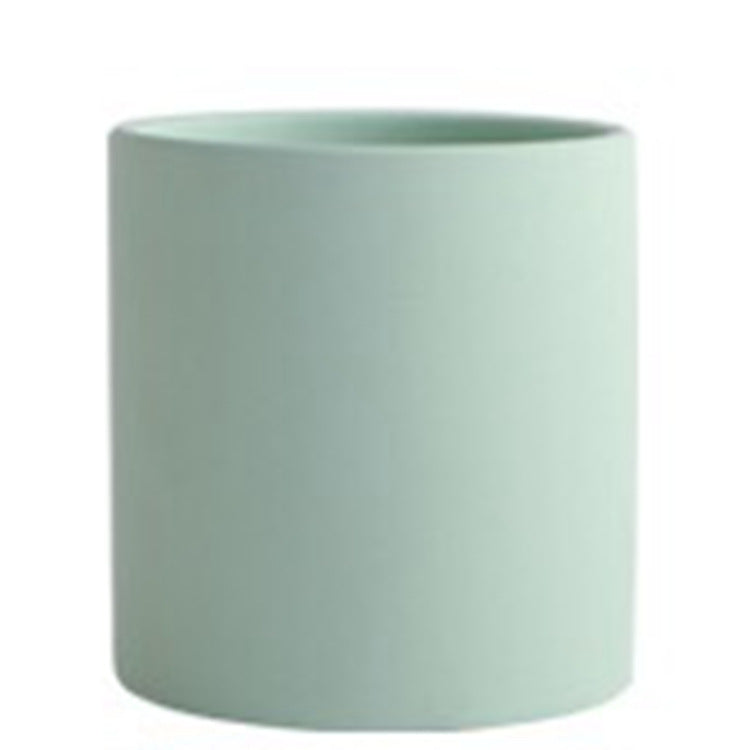Colorful cylinder ceramic succulent planter with drainage hole, shown in a Nordic-inspired minimalist style