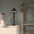 Minimalist LED desk lamp with built-in charging pad on a bedside table, soft warm light illuminating a modern bedroom