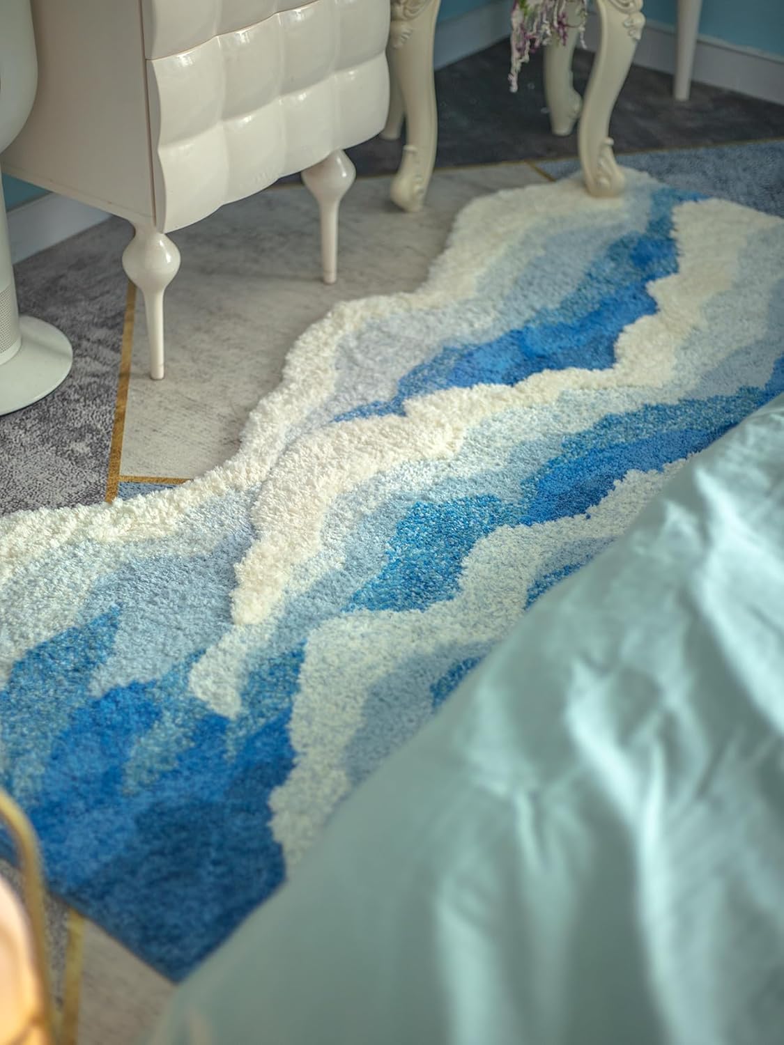 Fluffy wave-shaped bath mat with plush absorbent texture, shown in a soft neutral tone for bathroom decor