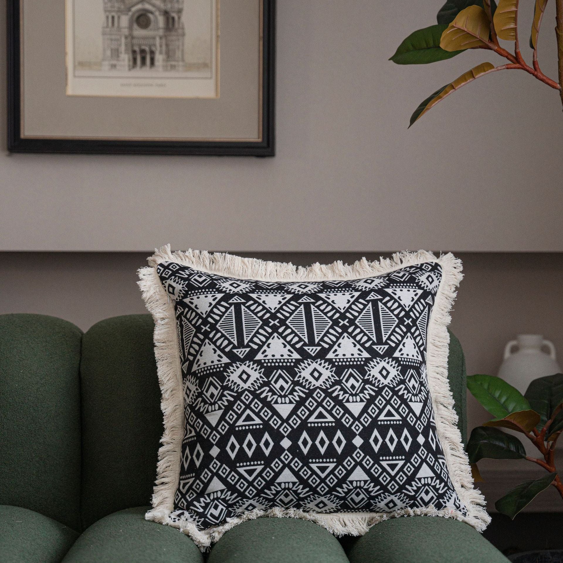 Close-up of jacquard floral throw pillow cover showing intricate woven pattern and decorative tassel detail along the edge