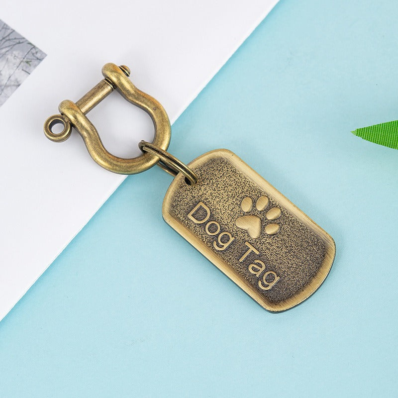 Round silver engraved pet ID tag with custom text, shown flat on a neutral background