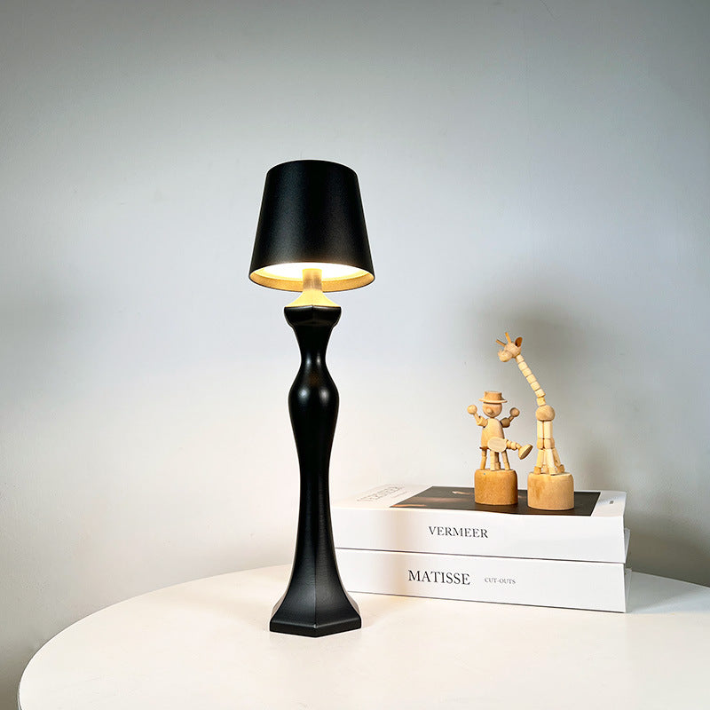Warm light table lamp casting a soft amber glow on a bedroom nightstand, ideal as a decorative night light