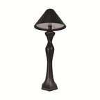 Minimalist LED desk lamp with built-in charging pad shown on a bedside table in a softly lit modern bedroom