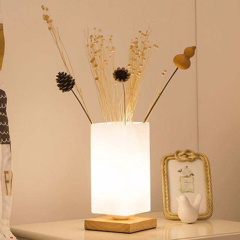 Solid wood table lamp with a Nordic minimalist design, featuring a natural wood base and warm ambient desk light