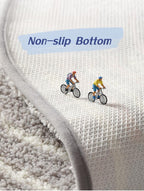 Fluffy wave-shaped bath mat laid flat on bathroom floor, showing soft absorbent texture and non-slip design