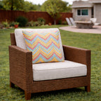 Two 18x18 waterproof outdoor throw pillows in neutral tones, shown on a patio chair for outdoor decor inspiration