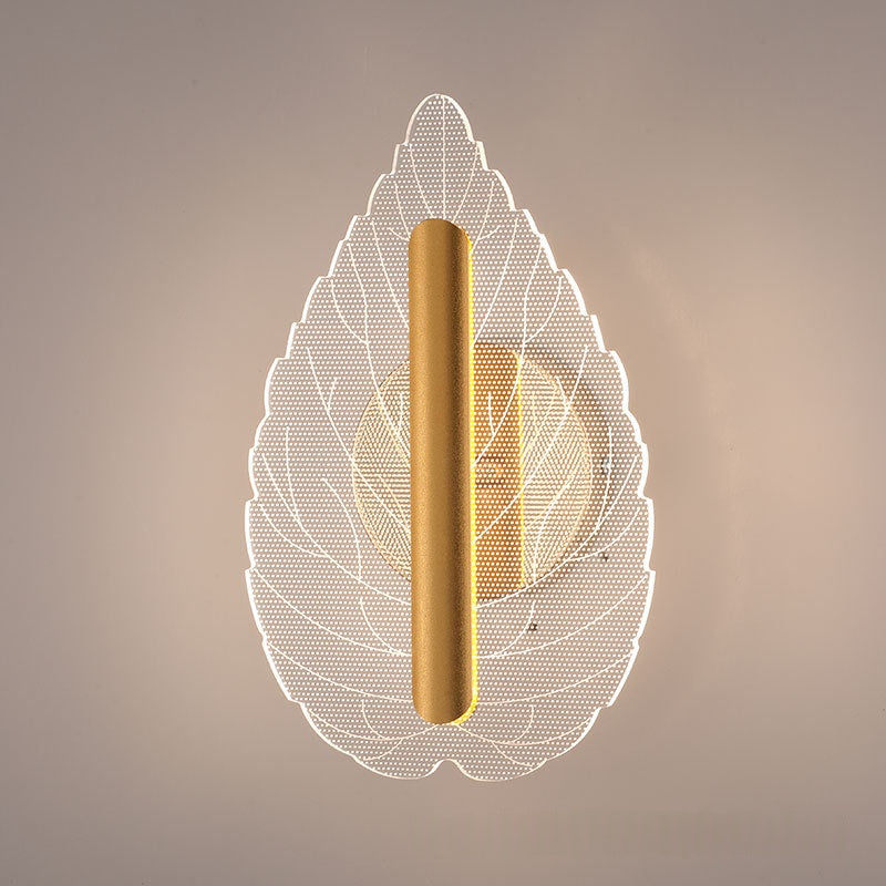 Modern minimalist leaf wall lamp with tri-color LED lighting mounted on an interior wall, shown in warm white glow