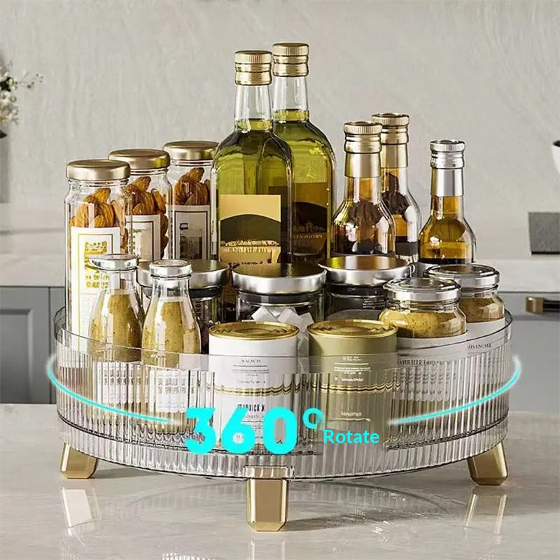 Clear rotating desktop storage box with multiple compartments, shown from a side angle highlighting the transparent design