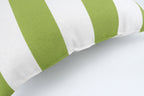 Two 18x18 green and white waterproof outdoor throw pillows displayed on a patio setting