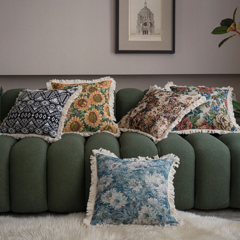 Close-up of jacquard floral throw pillow cover showing tassel fringe detail along the edge