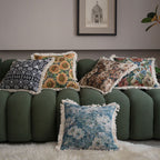 Close-up of jacquard floral throw pillow cover showing tassel fringe detail along the edge