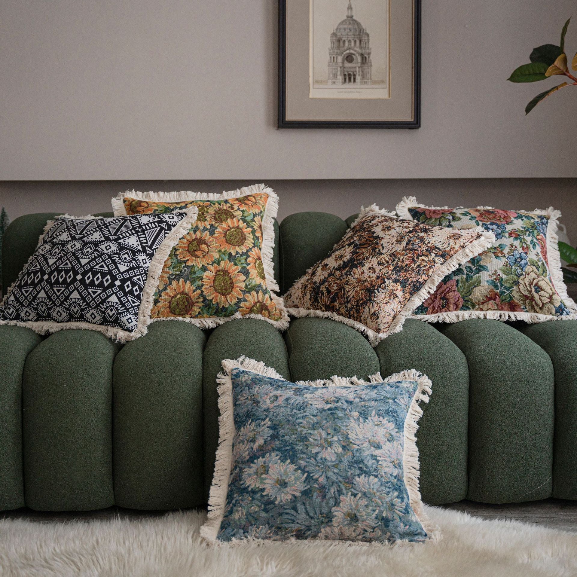 Close-up of jacquard floral throw pillow cover showing tassel fringe detail along the edge