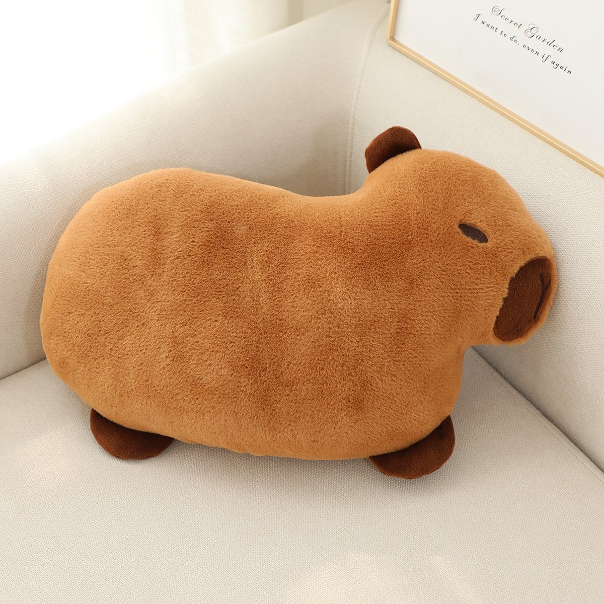Soft plush capybara embroidered decorative pillow cushion shown from a side angle highlighting texture detail