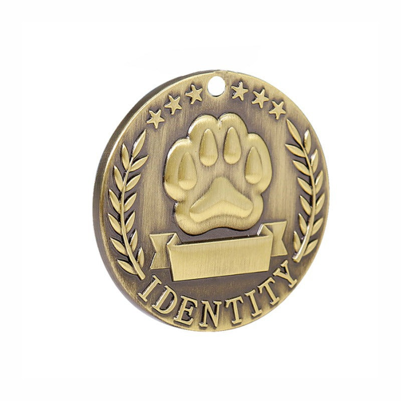 Round silver engraved pet ID tag with custom text, shown close up on a white background
