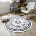 Nordic round area rug with minimalist geometric pattern in neutral tones, shown flat on floor