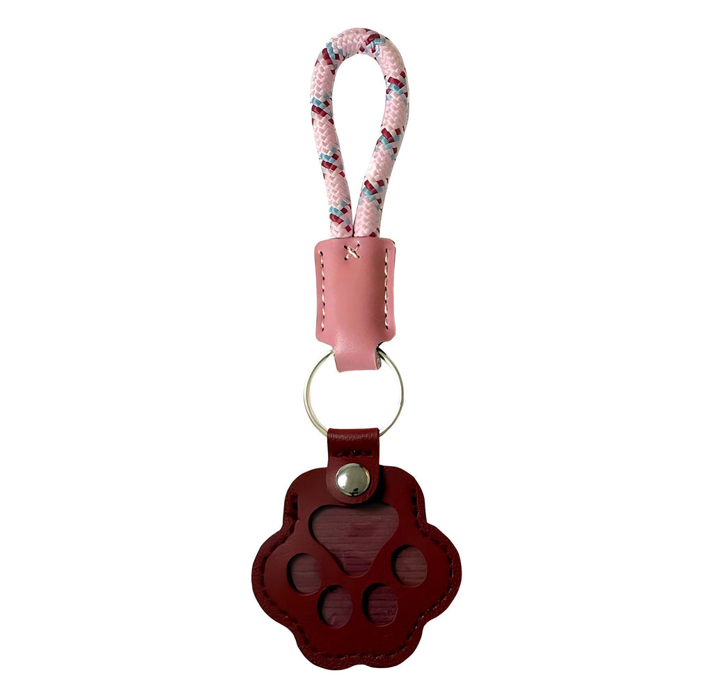 Paw-shaped brown leather keychain with a small window holding pet fur, a heartfelt memorial keepsake for dogs and cats