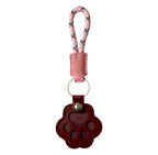 Paw-shaped brown leather keychain with a small window holding pet fur, a heartfelt memorial keepsake for dogs and cats