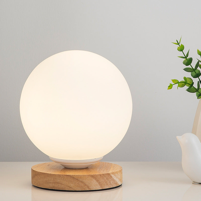Solid wood table lamp with Nordic minimalist design, shown from a side angle highlighting the natural wood grain and slim pro