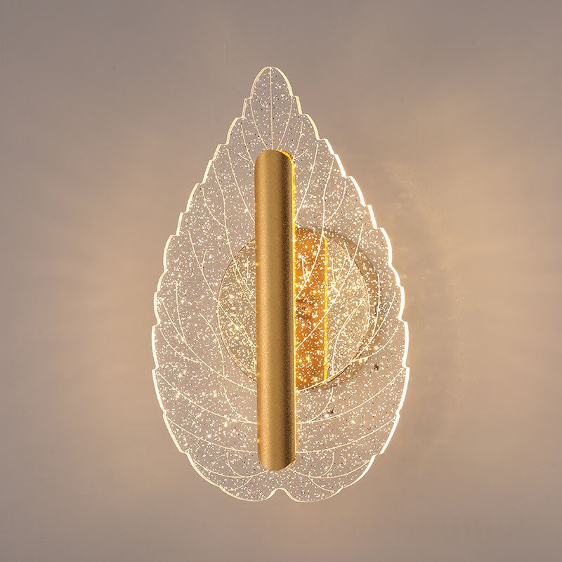 Modern minimalist leaf-shaped wall sconce with tri-color LED lighting mounted on an indoor wall
