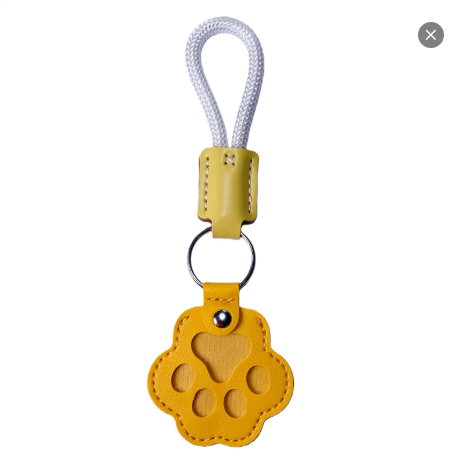 Paw-shaped leather memory keychain holding pet fur, a heartfelt keepsake gift for dog and cat owners