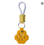 Paw-shaped leather memory keychain holding pet fur, a heartfelt keepsake gift for dog and cat owners