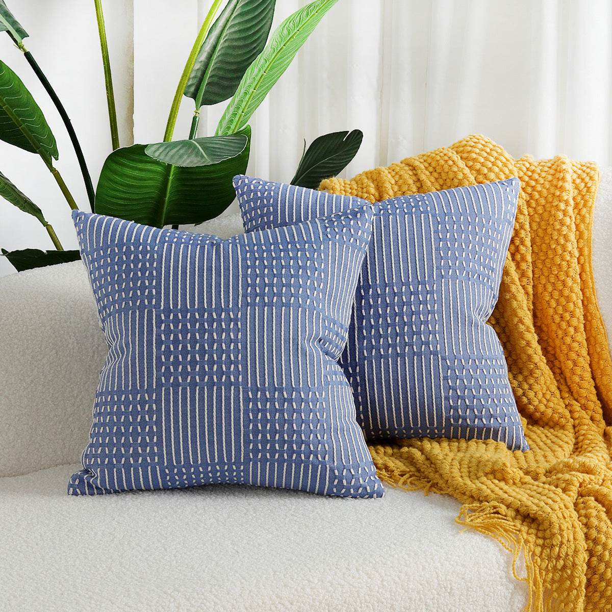 Geometric jacquard cotton pillow cover in a neutral woven pattern, shown flat to display texture and design detail
