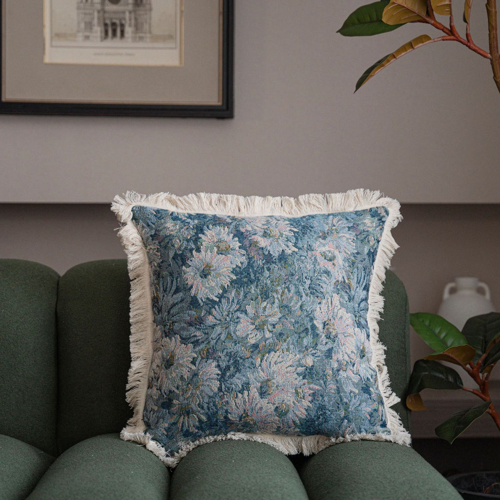 Close-up of jacquard floral throw pillow cover showing intricate woven pattern and decorative tassel fringe detail