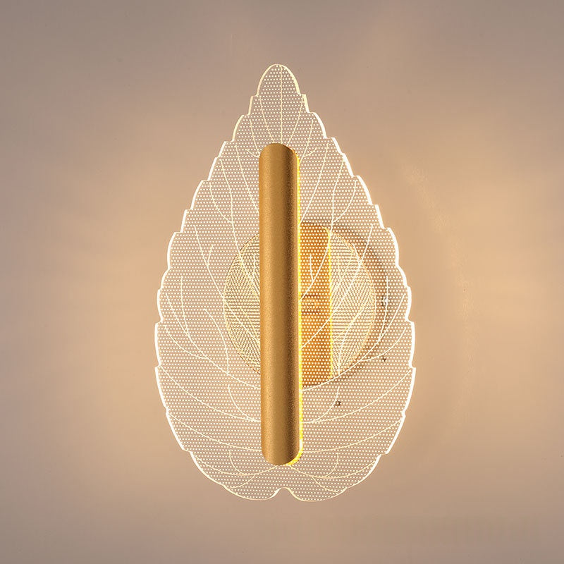 Modern minimalist leaf wall sconce glowing with warm tri-color LED light mounted on an interior wall