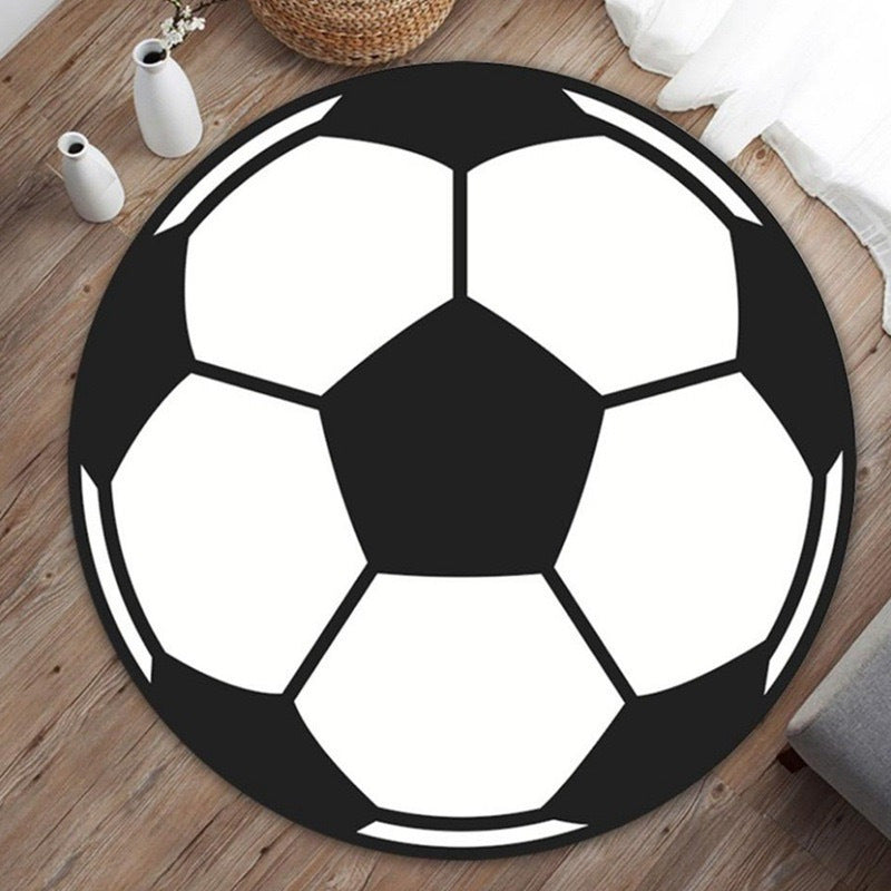 Round cartoon bedroom rug with colorful abstract animal art pattern, shown as a flat lay on a light floor