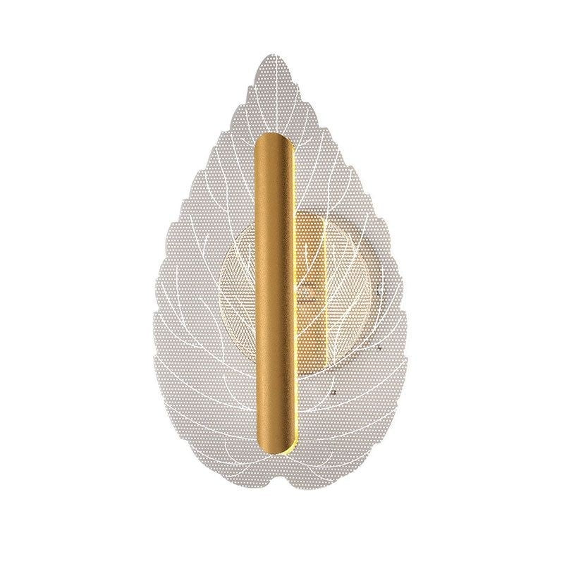 Modern minimalist leaf-shaped wall sconce glowing with warm tri-color LED light mounted on an interior wall