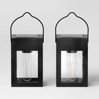 Matte black solar LED lantern path lights set of 2 placed along an outdoor garden walkway
