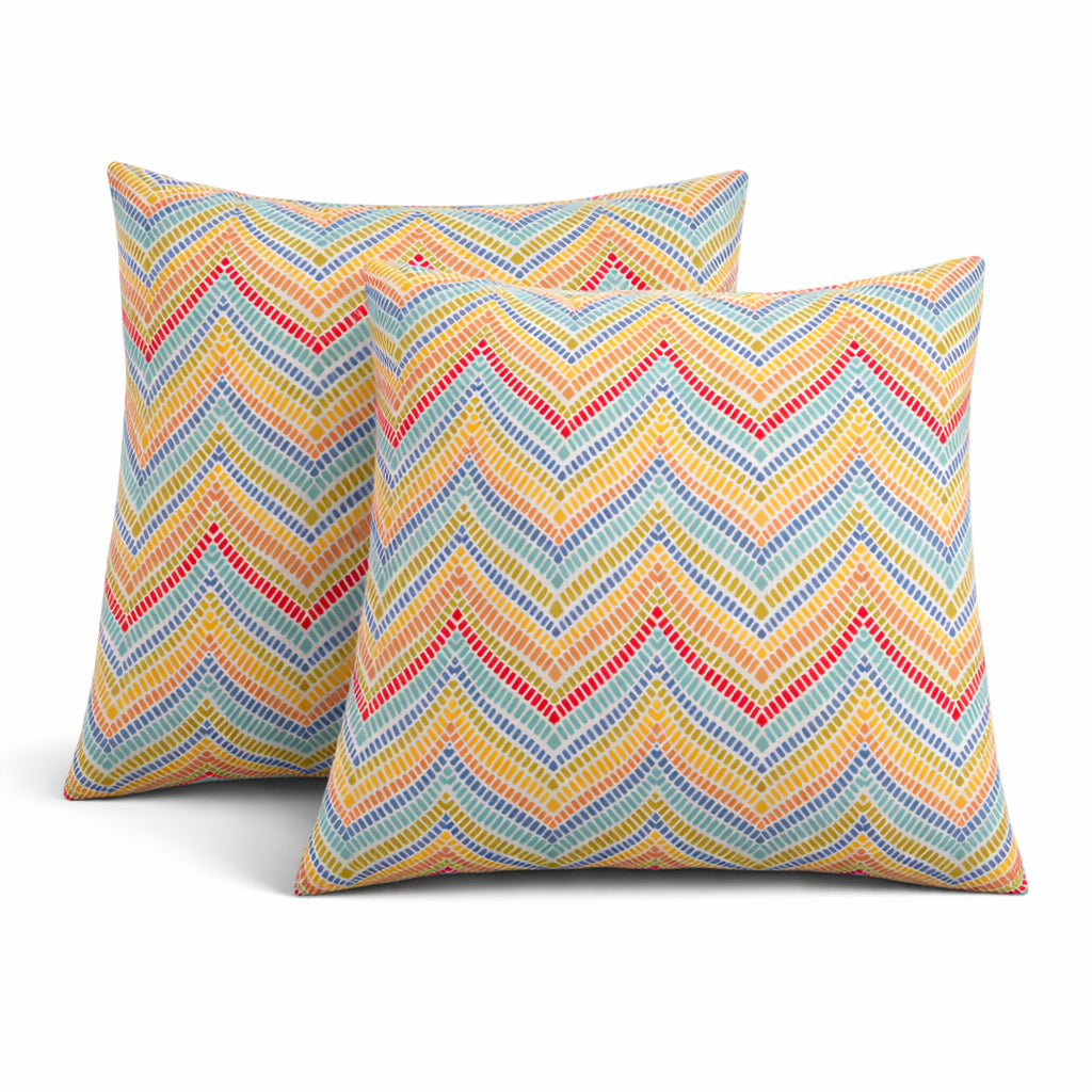 Two waterproof outdoor throw pillows 18x18 displayed on patio furniture, showing fade-resistant fabric and texture detail
