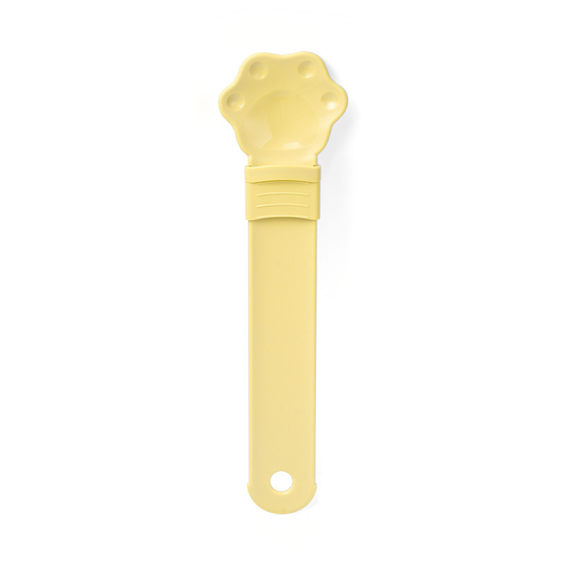 Cat treat squeeze spoon lickable feeder dispenser shown from the side, highlighting the soft silicone tip and squeeze tube de