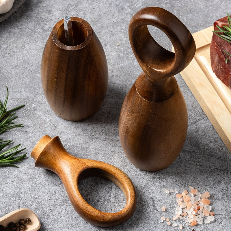 Desert Ironwood pepper mill standing upright, showcasing the natural wood grain texture and manual ceramic grinder mechanism