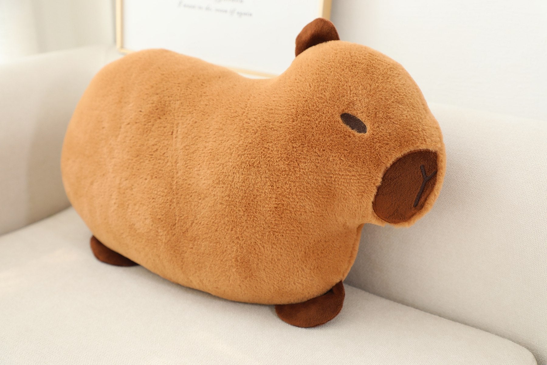Soft plush capybara pillow cushion with detailed embroidered face, shown from the front on a neutral background