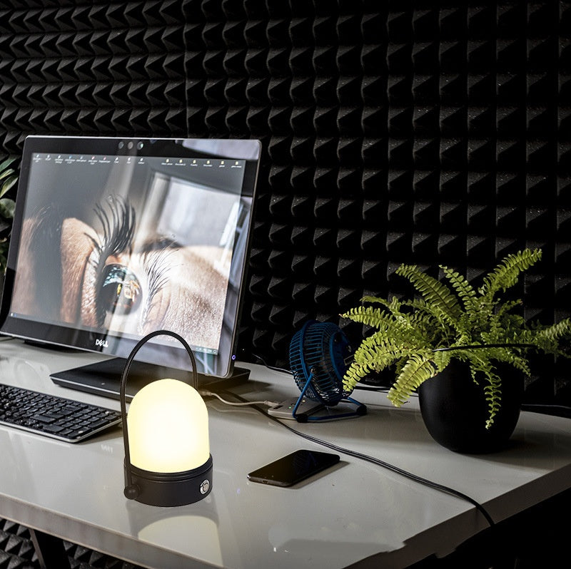 Rechargeable LED atmosphere night light glowing softly on a surface, showcasing its modern minimalist lamp design