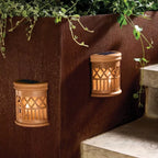 Two solar woven deck accent lights with warm filament LED glow, placed on outdoor wooden deck steps at dusk