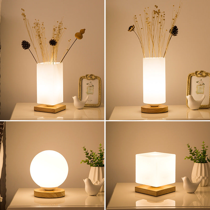 Nordic minimalist solid wood table lamp with a warm natural finish, shown as a modern desk light accent.