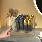 Clear rotating makeup organizer box holding lipsticks and brushes, showing 360-degree swivel base and transparent PET compart