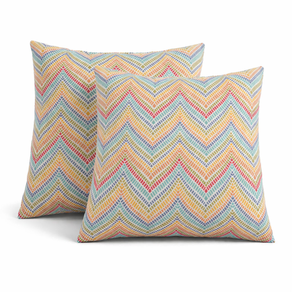 Two 18x18 outdoor throw pillows in neutral tones, waterproof and fade-resistant, shown on a patio chair