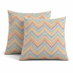 Two 18x18 outdoor throw pillows in neutral tones, waterproof and fade-resistant, shown on a patio chair