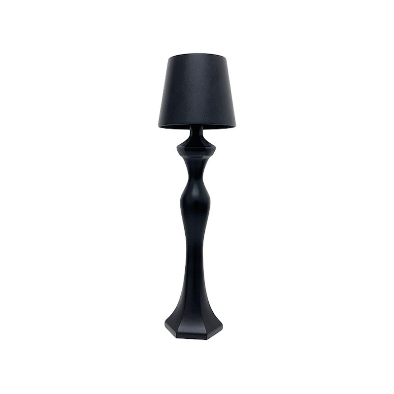 Warm light table lamp casting a soft amber glow on a bedside table, ideal for bedroom decor and nighttime ambiance.